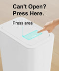 Hand pressing lid of Three Pack 10L Small Trash Cans With Lids Pop Up Lid Space Saving Slim Waste Baskets for kitchen