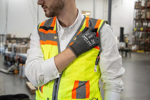 Person wearing Cut-Less Korplex Glove With Foam Nitrile Palm For Cut Resistance And Dexterity in large size, gray and black.