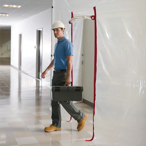 Worker using Heavy Duty Dust Barrier Zipper 2 Pack Self Adhesive Entry Door For Remodeling Jobs Red HDAZ2 in construction area.