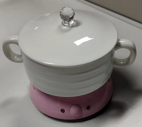 Top Shelf Electric Coffee Mug Warmer With Smart Temp Controls And Four Hour Auto Shutoff stays put on your desk with a pink base.
