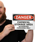 Man holding Heavy Duty Aluminum Hazard Warning Plate 7 X 10 Inches Built Like A Tank For Chemical Storage Areas And Authorized Personnel Only Rust Free Fade Resistant Print.