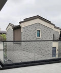 Heavy Duty Glass Railing System For Deck And Balcony Featuring Rock Solid Spigot Clamps installed around a balcony area.