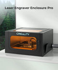 Creality Laser Engraver Enclosure Pro front view with black enclosure and orange-lit viewing window