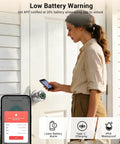 A woman using the No Sweat Fingerprint Smart Door Knob Lock With Nifty Keypad And Phone App Control For Quick Everyday Access and Locked Down Home Security In Fresh Bright Silver Finish to check battery alert on her phone.
