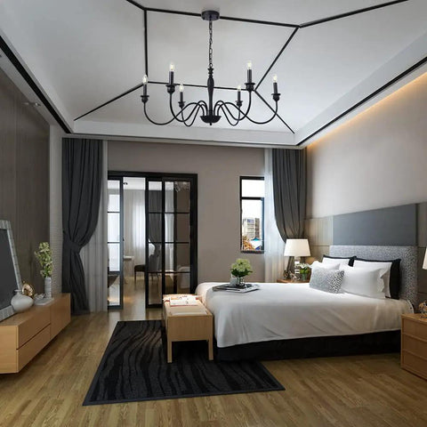 Six Light Farmhouse Chandelier In Black Iron For Dining Room And Kitchen Island Rustic Industrial Ceiling Light Fixture With Classic Candle Style Stems Perfect Foyer Living Room And Bedroom Lighting 38 Inch hanging above a modern bedroom.
