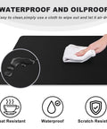 Person wiping Beast Mode Massive Gaming Mouse Pad Desk Mat 31.5x15.7 Inches with Stitched Edges Non Slip Waterproof Rubber Base.