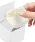 Person placing candle into White Square Cardboard Boxes Set Of 10 Easy Assembly Packaging Boxes For Essential Oils Coffee Cups Candles And Gifts