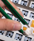 Close-up of hand using tweezers on Two Layer Switch Lubrication Station For Mechanical Keyboards With Quick 33 Switch Lube Capability