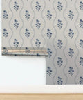 Kick Up Walls With Cottage Floral Blue And Silver Metallic Wallpaper Featuring Slick Fibrous Texture And Glamorous Shine on a smooth wall.