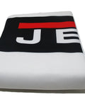 Folded white cloth with black and red logo, possibly related to Pro Grade 30-Micron Filter Bag Kit For Vortex Cone Dust Collectors.