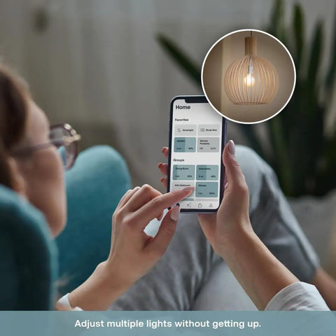 Person controlling lights using app with Game Changing Smart Dimmer Switch Crafted For Single Pole Circuits Featuring Effortless Wifi Linkup And Voice Commands Via Alexa Or Google Home.