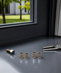 Legit 4 Pack Heavy Duty Gold Metal Lamp Pipe Coupler Adapter Connects Fixture Threads Perfectly For Your Next Sick DIY Lighting Projects With Heat Resistant Zinc Alloy Build Holds Tough So You Can Skip The Tools Get It Done Right No Sweat. Four zinc alloy lamp couplers on a table