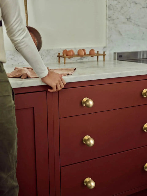 Solid Brass Cabinet Knob Set Of 6 Unlacquered Brass Round Ball Drawer Pulls For Kitchen Cabinets Vanity Dresser One And One Eighth Inch Diameter Living Patina Finish on red drawers in kitchen.