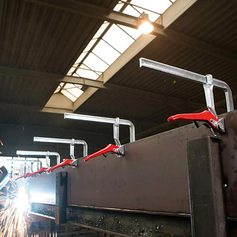 Heavy Duty 20 Inch Lever Clamp With Quick Grab Ratchet Jaw Dead Nuts Cold Drawn Steel Frame securing metal beams in workshop.