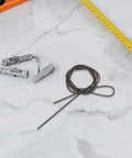 Premium Manganese Steel Mechanical Extension Spring Kit With Dual Hooks Offers Serious Traction, Adjustable Firm Hold And Durable Industrial Performance For Any Tough Job You Need To Get Done Fast. Extension spring kit with gray wall plugs and metal wire on tile