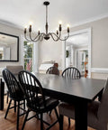 Dining room with Six Light Black Modern Farmhouse Chandelier With Rustic Vintage Candle Iron Arms In Matte Black Finish