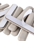 Close-up of 16 Piece Self Stick Furniture Sliders For Carpet Floors, beige HDPE pads showcasing tough adhesive backing.