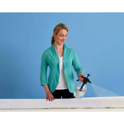 Woman using spray to install Minnie Fashionista Water Activated Peel And Stick Wall Mural Removable Disney Wall Decor 10.5 Ft By 6 Ft