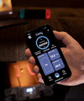 Person holding smartphone displaying Bluetooth monitoring for Straight Up Badass 4000W Modified Sine Wave Truck Power Inverter.