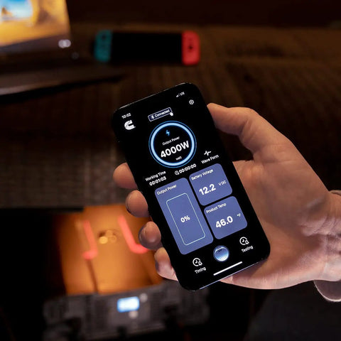 Person holding smartphone displaying Bluetooth monitoring for Straight Up Badass 4000W Modified Sine Wave Truck Power Inverter.