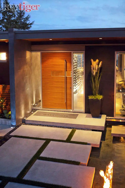 Modern home entrance featuring 12 Inch Two Sided Stainless Steel Matte Black Door Handle Pull For Modern Front Doors And Glass Entrances Double Sided Pull Bar For Commercial Sliding Barn Interior And Exterior Use Pro Grade Built To Last on a wooden door with a glass panel.