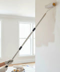 Adjustable height Legit Game Changer Paint Roller Kit With Extendable Stainless Steel Pole painting a wall.