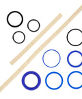 Hydraulic cylinder seal kit with assorted O-rings (black/blue) and beige seal strips, flat lay