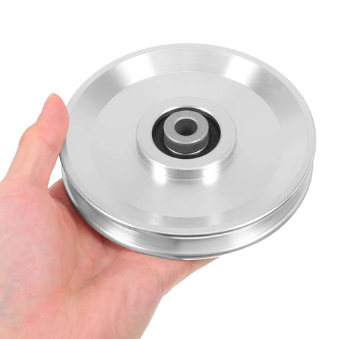 Hand holding Heavy Duty Aluminum Cable Pulley Wheel for Gym Gear and Clotheslines 115mm Diameter Silent Operation With Sturdy Bearings 551lb Load