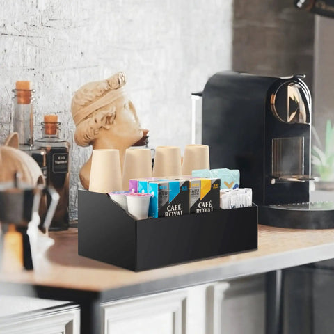 Acrylic Coffee Station Organizer for Countertops and Coffee Bars with 4 Compartments for Coffee Pods Tea Bags Sugar Stirrers Straws Cups Black Finish Durable Waterproof Easy to Clean and Keeps Your Counter Looking Neat and Ready displayed on a countertop with coffee machine in background