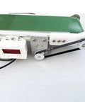 Smooth Operator Mini Desktop Conveyor Belt With Quick Gear Tuning And Heavy Duty DC Motor showing drive and speed control panel.