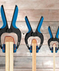 Medium Bandy Clamps Set For Woodworking With Easy Squeeze One Handed Operation, black and blue clamps on wood molding
