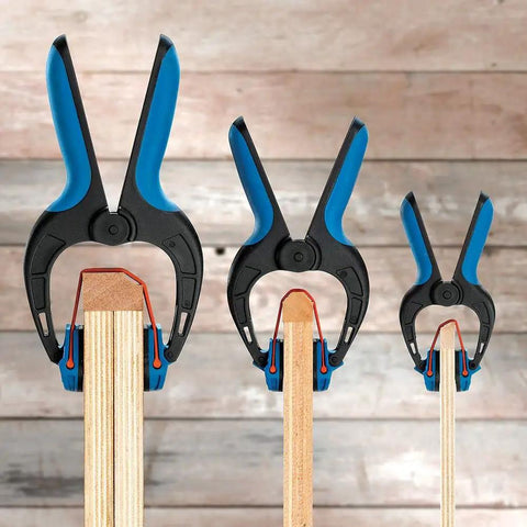 Medium Bandy Clamps Set For Woodworking With Easy Squeeze One Handed Operation, black and blue clamps on wood molding