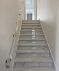 Rock Solid Clear Acrylic Stair Handrail With Snap Lock Wall Brackets, sleek grip handle on indoor stairway with marble steps.