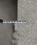 Straight Shooter Carbide Tipped Concrete And Masonry Drill Bits Flat Shank High Strength Carbon Steel For Screws 5 32 X 5 1 2 Inches 10 Piece Pack drilling into concrete surface.