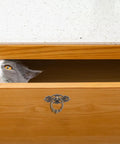 Wooden drawer with cat peeking out, featuring Six Piece Vintage Bronze Bail Drawer Pulls For Dresser Cabinet Jewelry Box And Furniture Antique Round Knob Hardware Retro Vibe Durable Zinc Alloy Construction Classic Decorative Pull Handles.