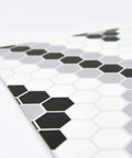 Close-up of geometric black peel and stick vinyl floor tiles pack of 10 12x12 inches, water resistant and washable with permanent adhesive.
