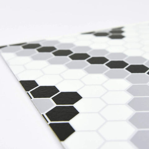 Close-up of geometric black peel and stick vinyl floor tiles pack of 10 12x12 inches, water resistant and washable with permanent adhesive.