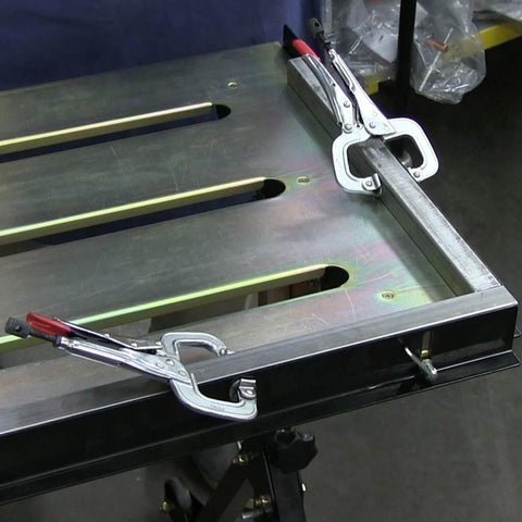 Worksite Ready Welding Table Pro Grade With 1.1 Inch Slot Top Adjustable Height And Tilt Casters For Easy Mobility Retractable Guide Rails Eccentric Leveling Feet Three Position Angled Tabletop For Horizontal 30 Degree Or Folded Storage Use, close-up view of slot top with clamps