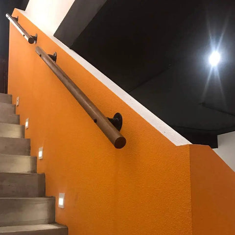 Rock Solid Wood Handrail With Heavy Duty Mount Brackets, Adjustable Non Slip Safety Grab Bar For Home Stairs, Hella Secure Support Rail For Seniors And Toddlers, No Sweat Wall Grip Setup on orange wall near stairs.