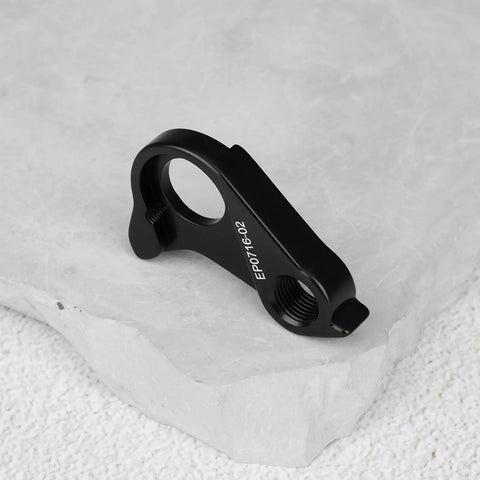 Black Rear Derailleur Hanger EP0716-02 on stone surface, aluminum alloy, replacement for Canyon 40 Endurace Inflite Aeroad Grail series