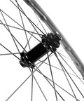Close-up of Fifty Twenty Five Millimeter Disc Brake Tubeless Wheelset For Road Bike 700c With Special Finish No Logos Carbon Fiber Toray T700 Rim Tubeless Ready Dope Shimano Eight Nine Ten Eleven Speed Compatible EN Quality Tested hub.