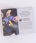 Open book with hands holding sustainable materials, text on page, Sustainable Materials For Product Design A Practical No Nonsense Guide For CMF Designers With Eco Friendly Material Choices Clear Structure And Visually Rich Guidance To Create Green Dope Products.
