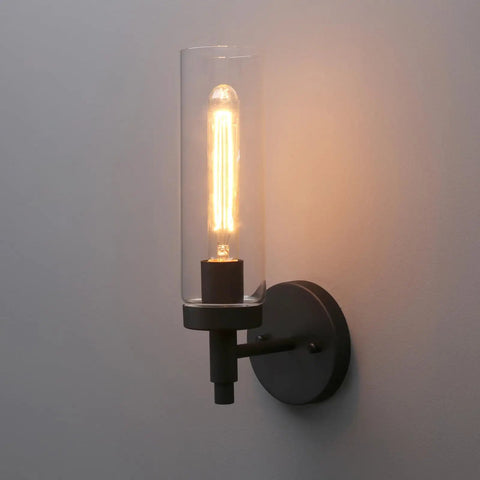 Matte Black Rustic Industrial Wall Sconce Light With Tubular Clear Glass Lampshade installed on wall