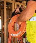 Worker using Non Conductive Electrical Fish Tape With Multi Groove Fiberglass Wire Puller Nylon Tip And Pro Grade Housing 100 Foot