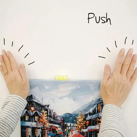 Hands demonstrating Place And Push Canvas Hangers For Drywall, 20 Pound Capacity, White, Easy Secure Wall Art Hanging System