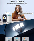 Woman using voice command to control 100W Smart LED Security Flood Light With Motion Sensor via Alexa and app, showing light in use.