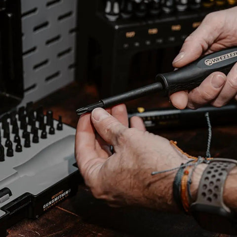 Pro Spec 43 Piece Gunsmithing Screwdriver Set With Grip Tight Handles and Built Tough S2 Steel bits being used in hand.