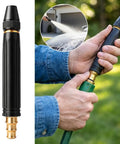 Man using Upgraded Beefed Up High Pressure Water Gun With Booster Nozzle For Home Cleaning And Car Wash on a sunny day