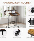 Mobile Split-Top Sit Stand Desk With Nifty Cup Holder, Smooth-As-Butter Manual Height Adjustment Knobs, ergonomic workstation with hanging cup holder.