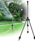 Stainless Steel Tripod Sprinkler Stand With Adjustable Height From 57.5 To 90 Cm G1 2 Thread Base in garden setting